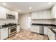 Fully equipped kitchen with stainless steel appliances and white cabinets, complete with tile flooring at 2807 N 8Th Ave, Phoenix, AZ 85007