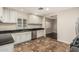 Bright kitchen featuring white cabinets, stainless steel appliances, and dark granite countertops at 2807 N 8Th Ave, Phoenix, AZ 85007