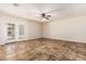 Spacious living area with tile flooring, a ceiling fan, and double doors leading to the outside at 2807 N 8Th Ave, Phoenix, AZ 85007
