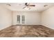 Large living space with tile floors, ceiling fan, and double doors for natural light and access at 2807 N 8Th Ave, Phoenix, AZ 85007