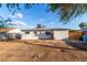A view of the back of the home, showing the windows, patio and a portion of the backyard at 3012 W Butler Dr, Phoenix, AZ 85051