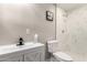 Bathroom featuring marble-like tile, walk-in shower, toilet, modern faucet and neutral paint at 3012 W Butler Dr, Phoenix, AZ 85051