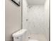 Bathroom featuring marble-like tile walk-in shower, modern shower head and fixtures at 3012 W Butler Dr, Phoenix, AZ 85051