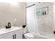 Bright bathroom featuring marble-like tile, shower-tub, black fixtures and bright window for natural light at 3012 W Butler Dr, Phoenix, AZ 85051