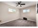 Cozy bedroom with neutral paint, plush carpet, and natural light from two windows at 3012 W Butler Dr, Phoenix, AZ 85051