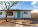 Charming single-story home featuring desert landscaping and a vibrant turquoise front door at 3012 W Butler Dr, Phoenix, AZ 85051