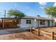Charming single-story home featuring a carport, desert landscaping, and vibrant turquoise front door at 3012 W Butler Dr, Phoenix, AZ 85051