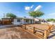 Charming single-story home featuring a carport, desert landscaping, and vibrant turquoise front door at 3012 W Butler Dr, Phoenix, AZ 85051