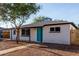 Charming single-story home featuring desert landscaping and a vibrant turquoise front door at 3012 W Butler Dr, Phoenix, AZ 85051