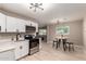 Well-lit kitchen with stainless steel appliances, white cabinets, and dining area at 3012 W Butler Dr, Phoenix, AZ 85051