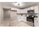 Updated kitchen with white cabinets, stainless steel appliances, and quartz countertops at 3012 W Butler Dr, Phoenix, AZ 85051