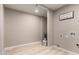 Spacious laundry room with light wood flooring, neutral paint, and washer and dryer hookups at 3012 W Butler Dr, Phoenix, AZ 85051
