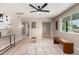 Open living room with light wood floors, neutral walls, and large window for natural light at 3012 W Butler Dr, Phoenix, AZ 85051