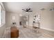 Bright living room featuring sleek ceiling fan, neutral walls, stylish furnishings, and light wood-look flooring at 3012 W Butler Dr, Phoenix, AZ 85051