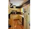 Compact kitchen with white appliances, wood-look flooring, and ample cabinet space at 333 W Seldon Ln, Phoenix, AZ 85021