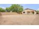 View of backyard featuring desert landscaping, privacy wall, and covered back patio at 36199 W Prado St, Maricopa, AZ 85138