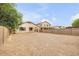 Wide shot of a desert landscaped backyard with a perimeter privacy wall and desert landscaping at 36199 W Prado St, Maricopa, AZ 85138