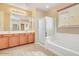 Well-lit bathroom with double sinks, spacious shower and separate soaking tub, perfect for relaxing at 36199 W Prado St, Maricopa, AZ 85138