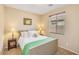 Relaxing bedroom featuring soft natural light from one window and two side tables with lamps at 36199 W Prado St, Maricopa, AZ 85138