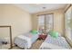 Bright bedroom with two twin beds, soft lighting and a neutral color palette, perfect for or guests at 36199 W Prado St, Maricopa, AZ 85138