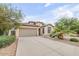 Inviting single-story home with a spacious driveway and desert landscaping at 36199 W Prado St, Maricopa, AZ 85138