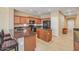Bright kitchen featuring tile flooring, a center island, breakfast bar, and black appliances at 36199 W Prado St, Maricopa, AZ 85138