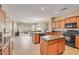 Spacious open-concept kitchen with stainless steel appliances, an island, and plenty of cabinets at 36199 W Prado St, Maricopa, AZ 85138