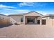The backyard features a covered patio and low-maintenance desert landscaping at 40816 W Sunland Dr, Maricopa, AZ 85138