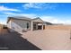 Spacious backyard with a covered patio, gravel groundcover, and block wall fencing for privacy at 40816 W Sunland Dr, Maricopa, AZ 85138
