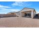 View of backyard showing desert landscaping, covered patio, and block wall at 40816 W Sunland Dr, Maricopa, AZ 85138