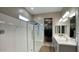 Bright bathroom with a glass-enclosed shower, double vanity, and walk-in closet at 40816 W Sunland Dr, Maricopa, AZ 85138