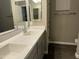 Bathroom featuring a dual sink vanity and a large mirror at 40816 W Sunland Dr, Maricopa, AZ 85138