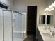 Bathroom with dual sink vanity, shower, and walk-in closet at 40816 W Sunland Dr, Maricopa, AZ 85138