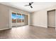 Bright and airy bedroom with a ceiling fan, sliding glass door, and tile flooring at 40816 W Sunland Dr, Maricopa, AZ 85138