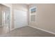 Bedroom with light walls, carpet flooring, sliding closet doors, and a window with blinds at 40816 W Sunland Dr, Maricopa, AZ 85138