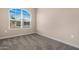 Bedroom featuring neutral walls, carpet floors, an outlet, and a large window with blinds at 40816 W Sunland Dr, Maricopa, AZ 85138