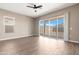 Bright and airy bedroom with a ceiling fan, sliding glass door, and tile flooring at 40816 W Sunland Dr, Maricopa, AZ 85138