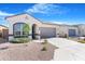 Charming single-story home with a two-car garage, landscaped front yard, and neutral color palette at 40816 W Sunland Dr, Maricopa, AZ 85138
