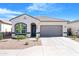 Charming single-story home with a two-car garage, landscaped front yard, and neutral color palette at 40816 W Sunland Dr, Maricopa, AZ 85138