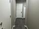 Hallway features gray plank flooring, neutral walls, and white doors at 40816 W Sunland Dr, Maricopa, AZ 85138