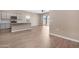Modern kitchen with stainless steel appliances and island, seamlessly integrated with an open living area at 40816 W Sunland Dr, Maricopa, AZ 85138