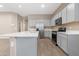 Bright kitchen featuring a large island, stainless steel appliances, and grey cabinets at 40816 W Sunland Dr, Maricopa, AZ 85138