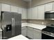 Updated kitchen featuring stainless steel appliances, gray cabinets, and white quartz countertops at 40816 W Sunland Dr, Maricopa, AZ 85138