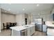 Open concept kitchen with a large island, stainless steel appliances, and adjacent dining area at 40816 W Sunland Dr, Maricopa, AZ 85138
