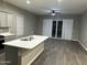 Bright kitchen and living space with a quartz island and wood-look tile flooring at 40816 W Sunland Dr, Maricopa, AZ 85138