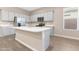 Bright kitchen featuring a large island, stainless steel appliances, and grey cabinets at 40816 W Sunland Dr, Maricopa, AZ 85138
