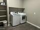 Laundry room features a modern washer and dryer with convenient shelving at 40816 W Sunland Dr, Maricopa, AZ 85138