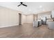 Open concept living space features wood-look tile floors and neutral color palette, perfect for modern living at 40816 W Sunland Dr, Maricopa, AZ 85138