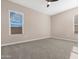 Bright main bedroom with carpet, offering comfortable living and great natural light from two windows at 40816 W Sunland Dr, Maricopa, AZ 85138