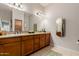 Bathroom with double vanity, granite countertops, and warm wood cabinetry at 4241 N Pebblecreek Pkwy # 7, Goodyear, AZ 85395